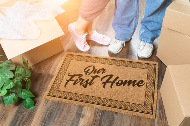 Man and Woman Unpacking Near Our First Home Welcome Mat, Moving