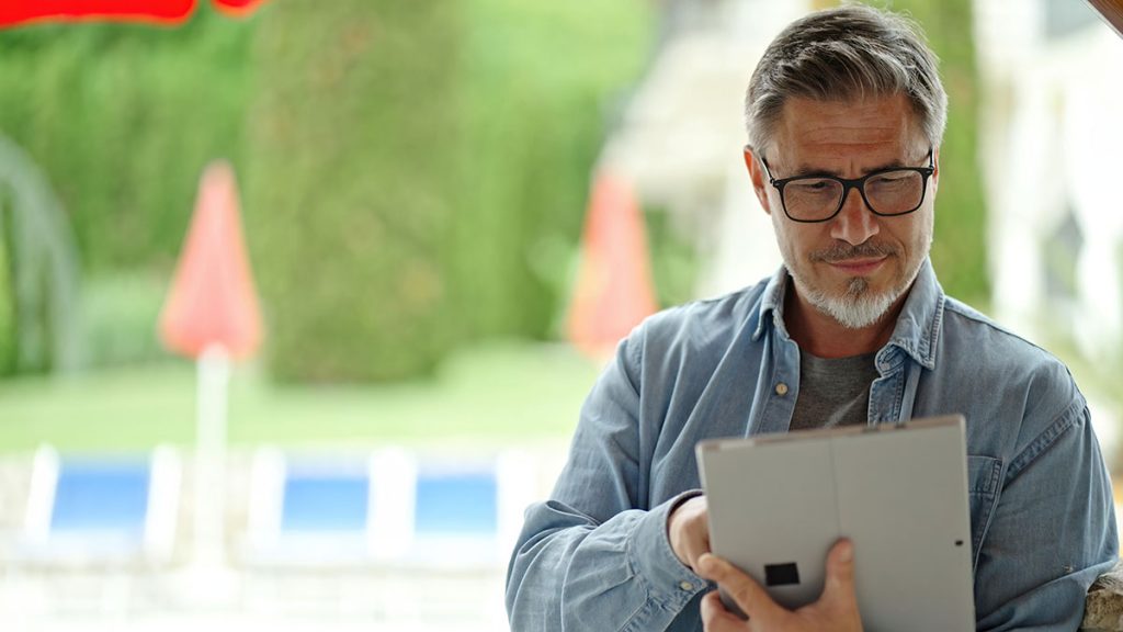 Home Inspector Using Tablet Outdoors in Garden