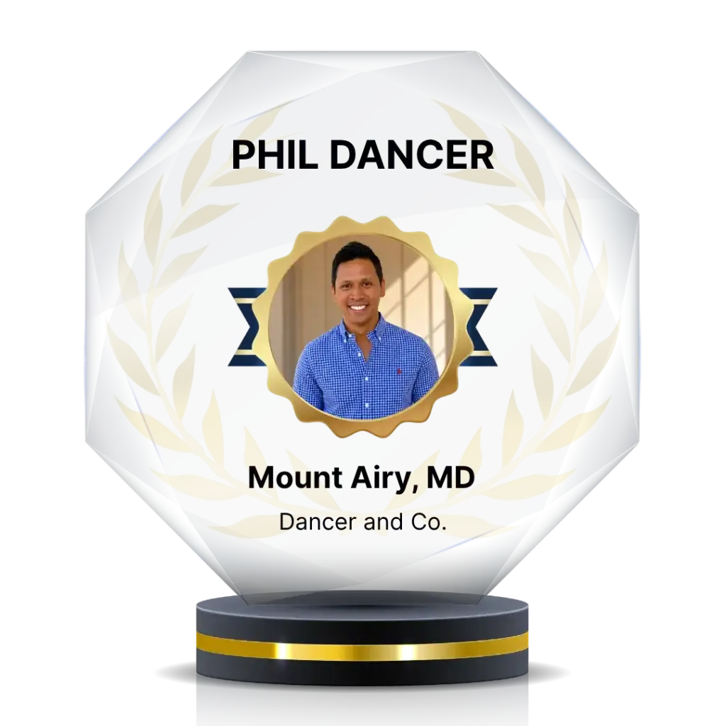 Award trophy displaying a photo of Phil Dancer with a gold seal and laurel wreath, text reads 'PHIL DANCER' and 'Mount Airy, MD' with 'Dancer and Co.' on a pedestal