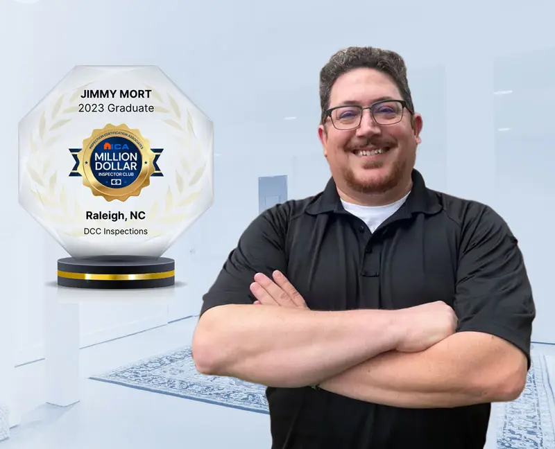 Smiling man with arms crossed beside a crystal award that reads ‘Jimmy Mort – 2023 Graduate, Raleigh, NC’.
